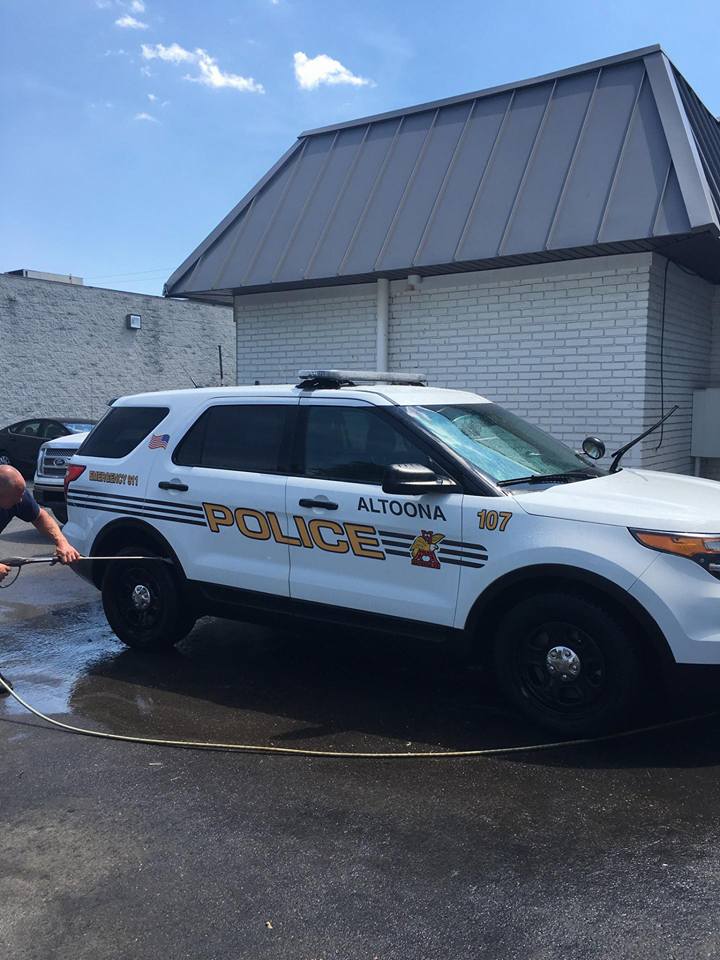 Altoona Police SUV being washed outside the shop