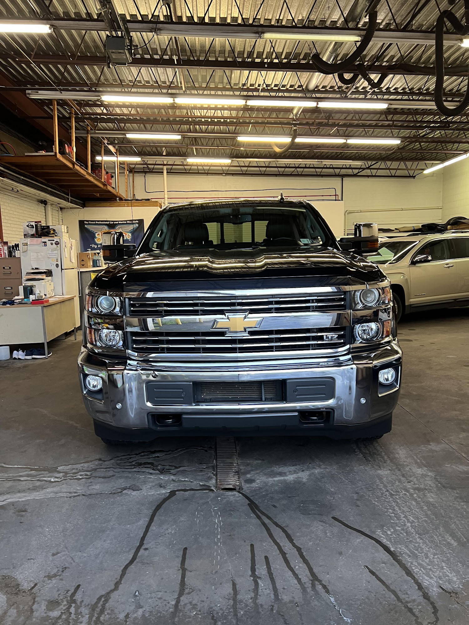 Black Chevrolet Silverado inside the detailing bay